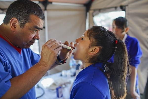 Image of a doctor examining a young girl