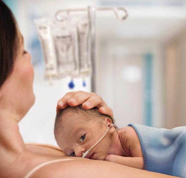 Premature baby in mother's arms